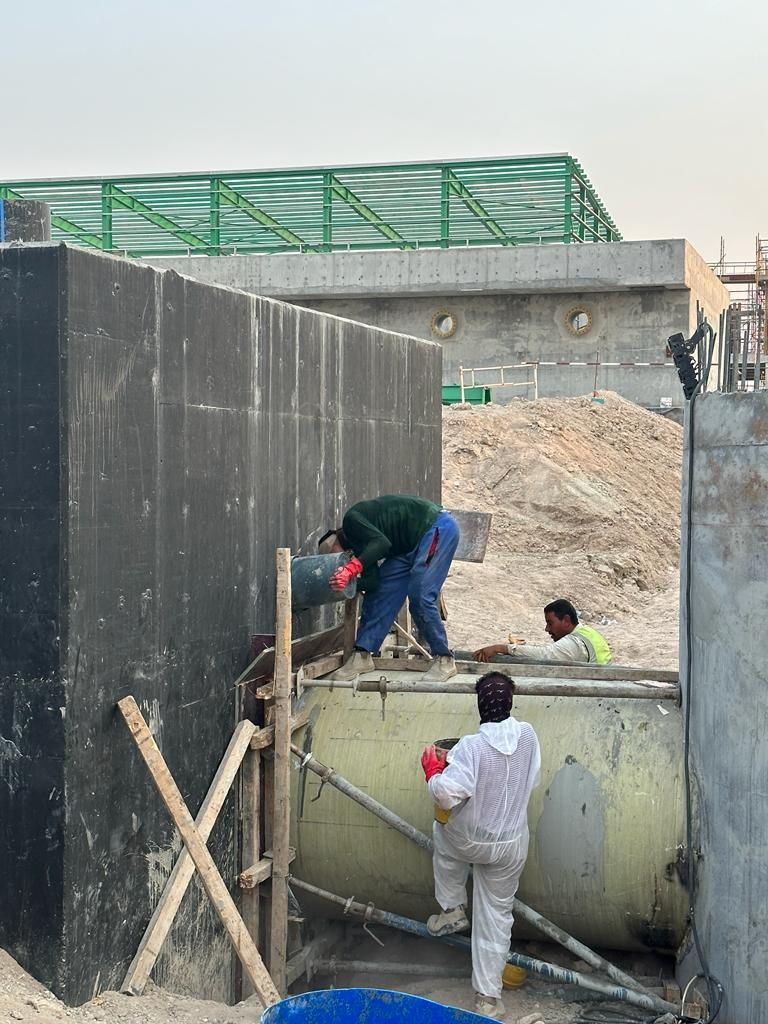 Workers completing the chemical pit tank at the WTP