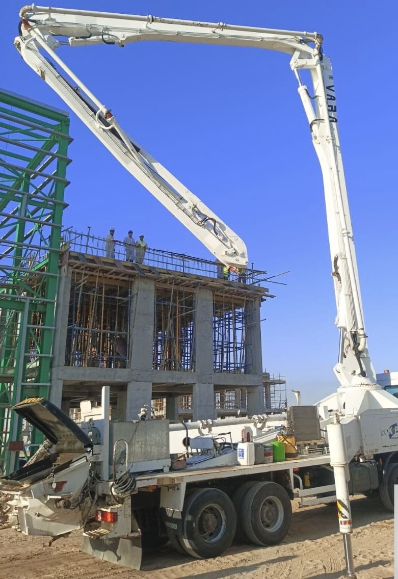 Concrete pump truck pouring a multi-storey building structure