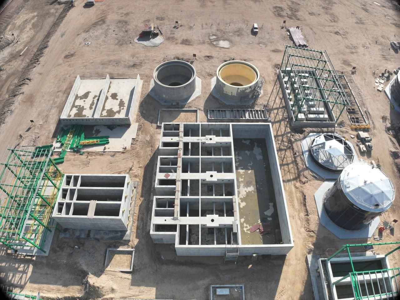 Aerial view of AAE water treatment plant construction with concrete tanks